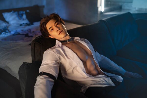 Luminous silicone boyfriend doll gay from Mendolls, posed flexibly in a neon-lit gay intimacy showcase.