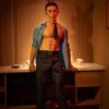 Mendolls realistic gay doll silicone, hyper-realistic and smooth, posed in a romantic Pride event setting