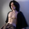 Silicone Asian boyfriend doll on bed