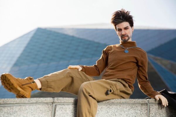 Alluring realistic silicone gay sex doll companion by Mendolls, lifelike in a starry gay passion scene.