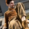 Alluring realistic silicone gay sex doll companion by Mendolls, in a neon Pride unveiling scene.