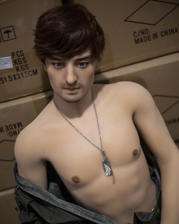 Beau gay sex doll sitting on leather sofa