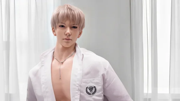 Mature anime schoolboy doll with open shirt and gentle expression