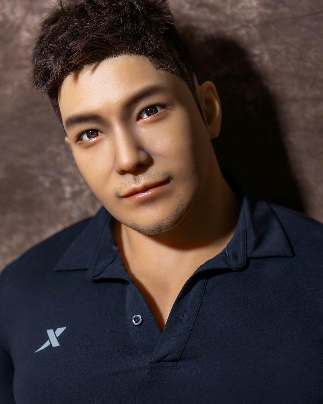 Gay man holding a realistic male companion doll in a cozy room