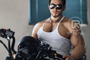 Realistic male doll sitting on a bed in natural light