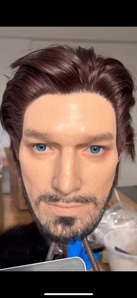 Close-up of a silicone male doll torso being washed for first use